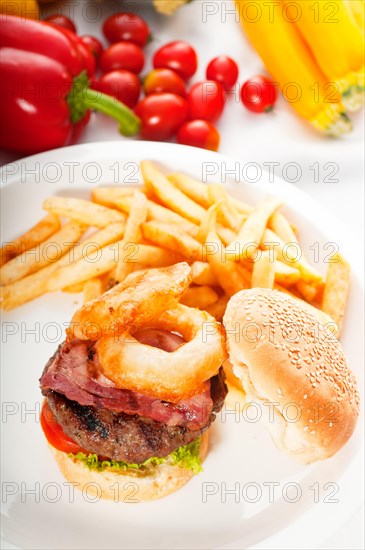 Classic american hamburger sandwich with onion rings and french fries