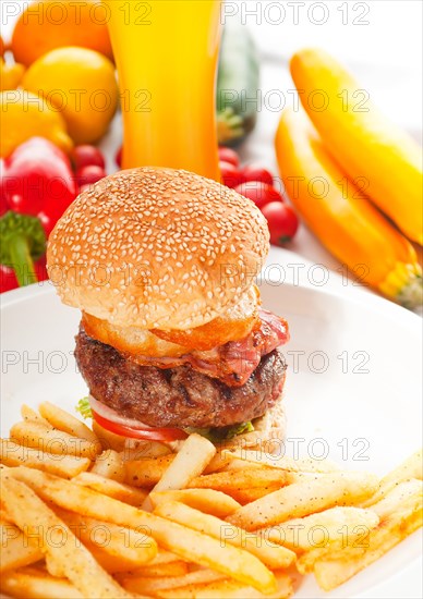 Classic american hamburger sandwich with onion rings and french fries