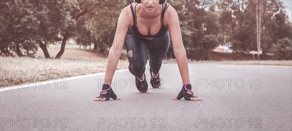 Image of a girl in headphones who stands in a lower position before starting to run. The concept of a healthy lifestyle. Mixed media