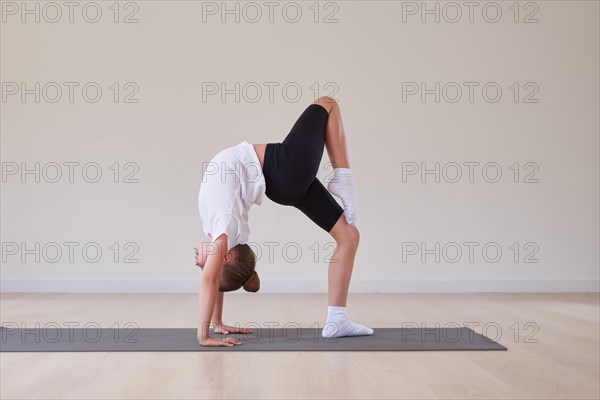 Little girl performs exercises in a gymnastics sports class. The concept of sports