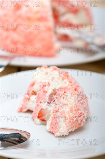 Fresh pink strawberry and whipped cream dessert macro close up