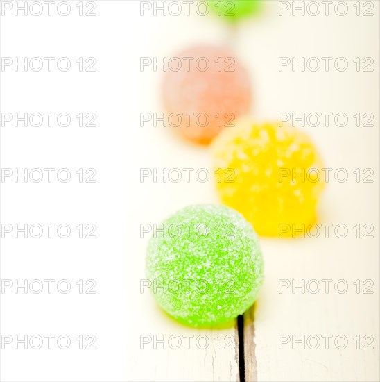 Sugar jelly fruit candy over white wood table