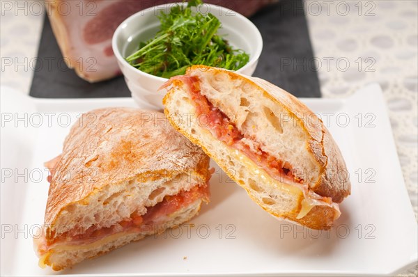 Italian ciabatta panini sandwich with parma ham and tomato