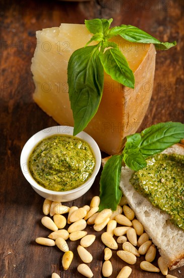 Italian basil pesto bruschetta ingredients over old wood macro