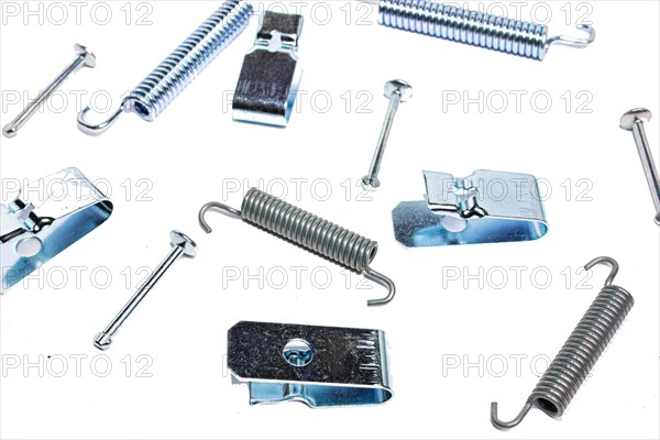 Repair kit of springs and clips for parking brake pads on white isolated background