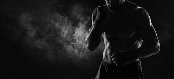 Noname image of a kickboxer on a dark background. The concept of mixed martial arts. MMA