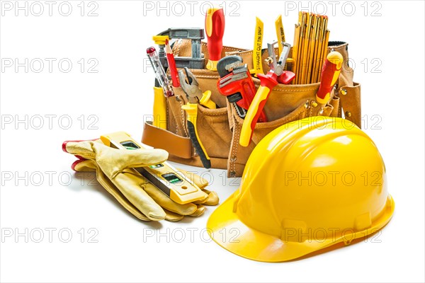 Helmet gloves and construction tools in tool belt isolated on white