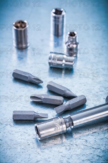 Metallic background with screwdriver and composition of steel screws and torxes Construction concept