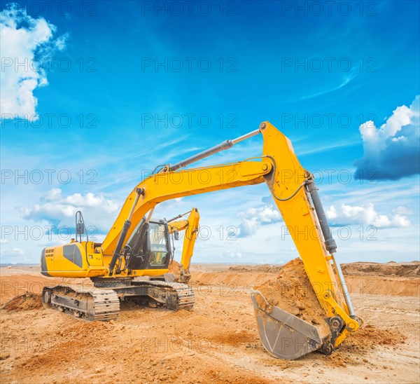 Excavator on construction site and sky background