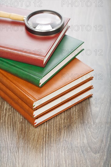 Five notebooks and magnifying glass