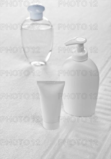 Plastic bottles on white cotton towel Towel