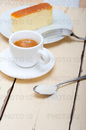 Italian espresso coffee and cheese cake over white wood table