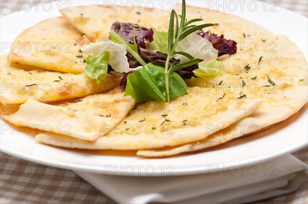 Fresh healthy garlic pita bread pizza with salad on top