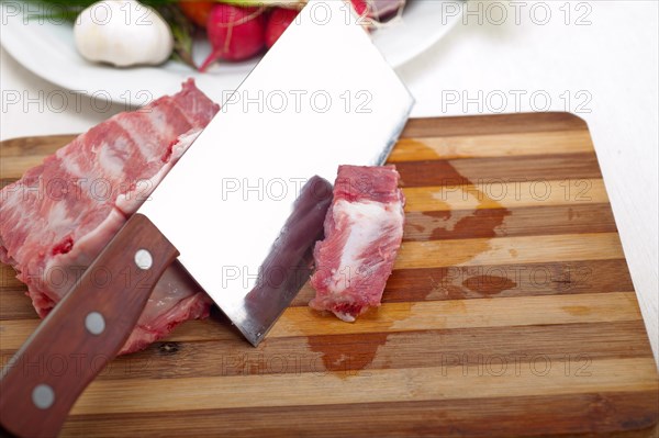 Fresh pork ribs with vegetables and herbs ready to cook