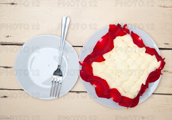 Whipped cream mango cake with red rose petals