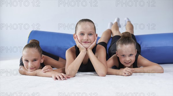 Image of a group of little girls in the gym after a workout. Gymnastics concept. Mixed media