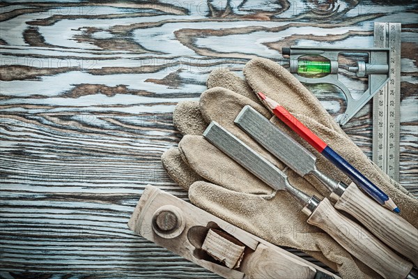 Set of carpenter tools on wooden board