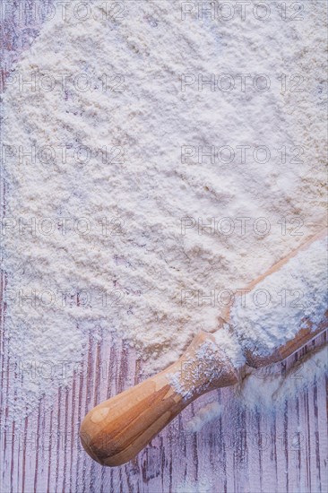 Copyspace photo handle of wooden rolling pin with white natural flour food and drink concept