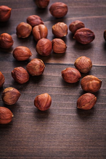 Hazelnut kernels on vintage wooden board Food and drink concept