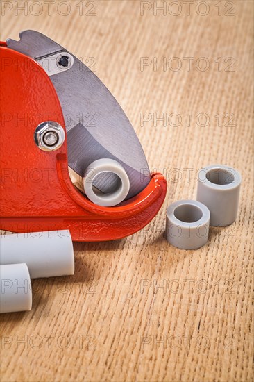 Pipe cutter with pipes on wooden plate