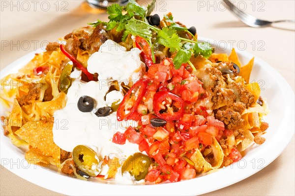 Fresh nachos and vegetable salad with meat