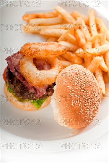 Classic american hamburger sandwich with onion rings and french fries