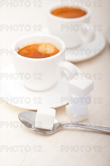 Italian espresso coffee fresh brewed macro closeup with sugar cubes