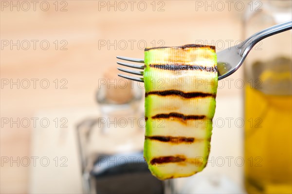 Grilled zucchini courgette on a fork macro close up