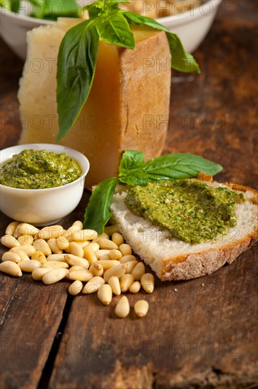 Italian basil pesto bruschetta ingredients over old wood macro