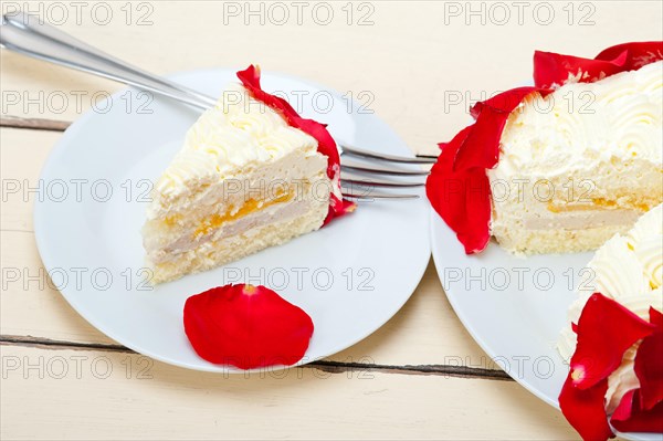Whipped cream mango cake with red rose petals