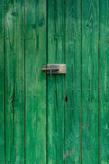 Old wooden door with aged metal door handle. Architectural textured background