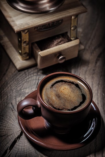 Brown coffee cup and mill close up view