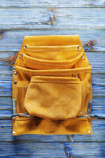 Leather tool belt on vintage wooden board