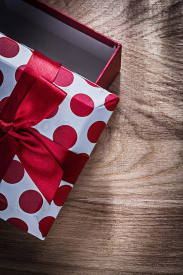Red gift box on wooden board vertical image celebrations concept