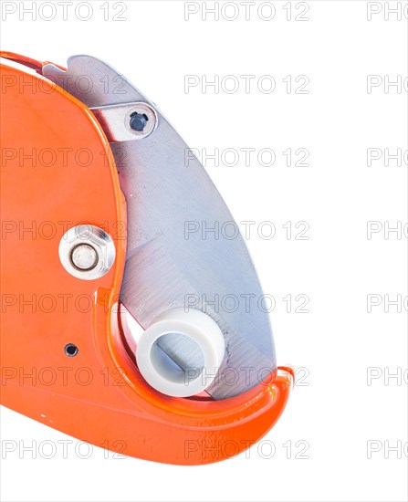 Close-up of a pipe cutter with insulated plastic pipe