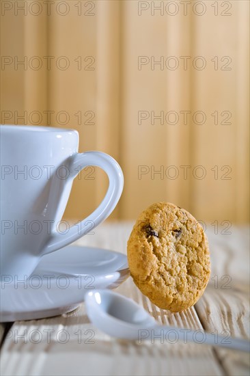 Closeup composition. blue coffee cup with spoon and biscuit