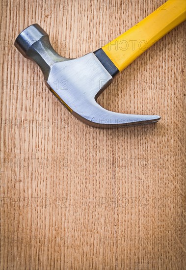 Copyspace image claw hammer on wooden board very close up