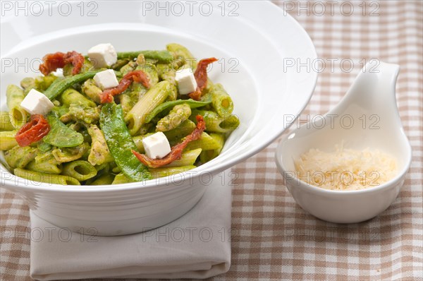 Classic Italian penne pasta with sundried tomato and basil