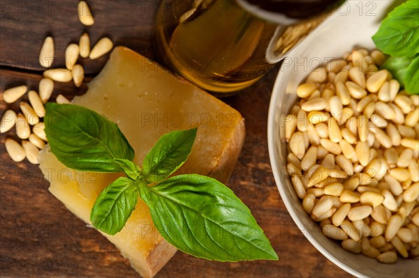 Italian basil pesto ingredients over old wood macro