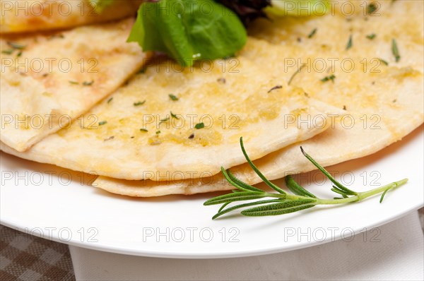 Fresh healthy garlic pita bread pizza with salad on top