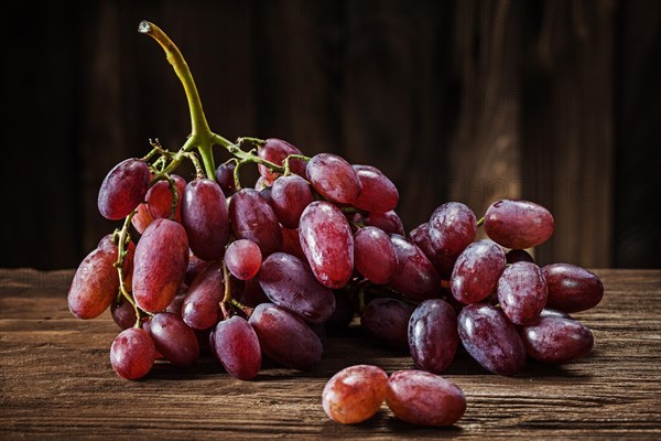 Rose grape bunch on vintage wooden background