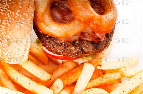 Classic american hamburger sandwich with onion rings and french fries