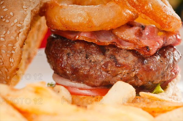 Classic american hamburger sandwich with onion rings and french fries