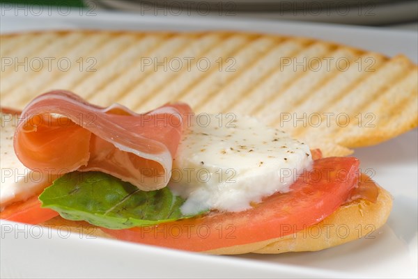 Panini sandwich with fresh caprese and parma ham