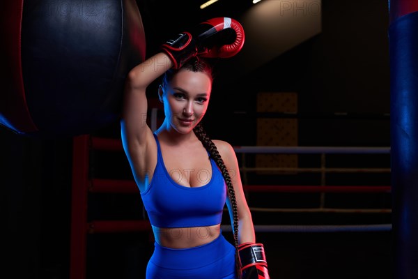 Woman boxer in red gloves. Sports concept