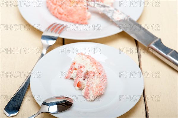 Fresh pink strawberry and whipped cream dessert macro close up