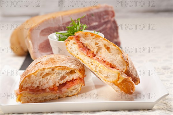 Italian ciabatta panini sandwich with parma ham and tomato