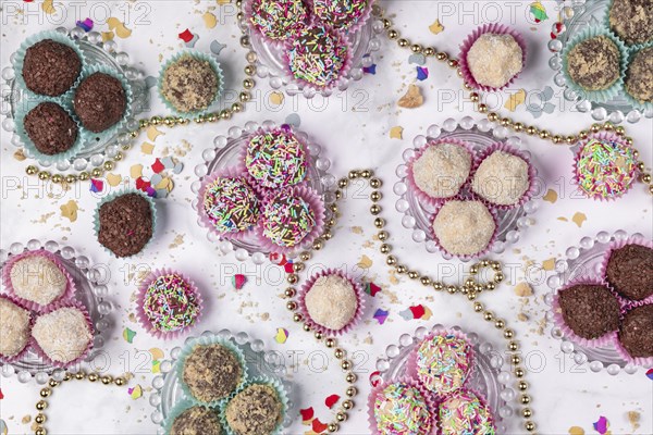 Light and dark rum balls on and next to glass plates