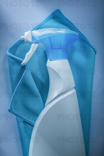 Blue washing cloth sprayer on white surface