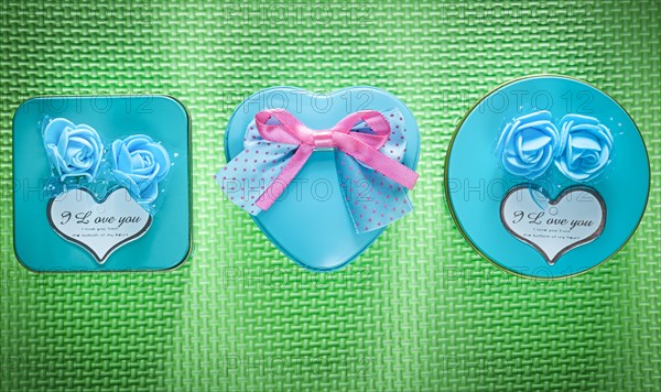 Composition of metal blue packed present boxes on green background holidays concept